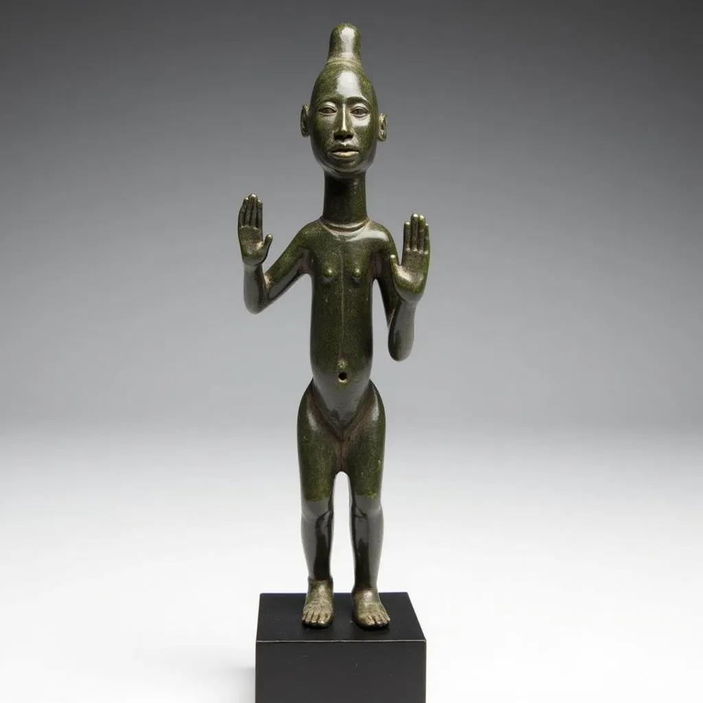 Dogon bronze figure with raised arms